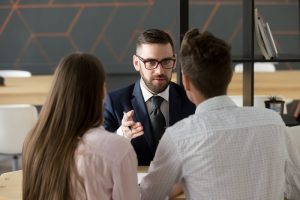 Salesman selling to clients at a meeting