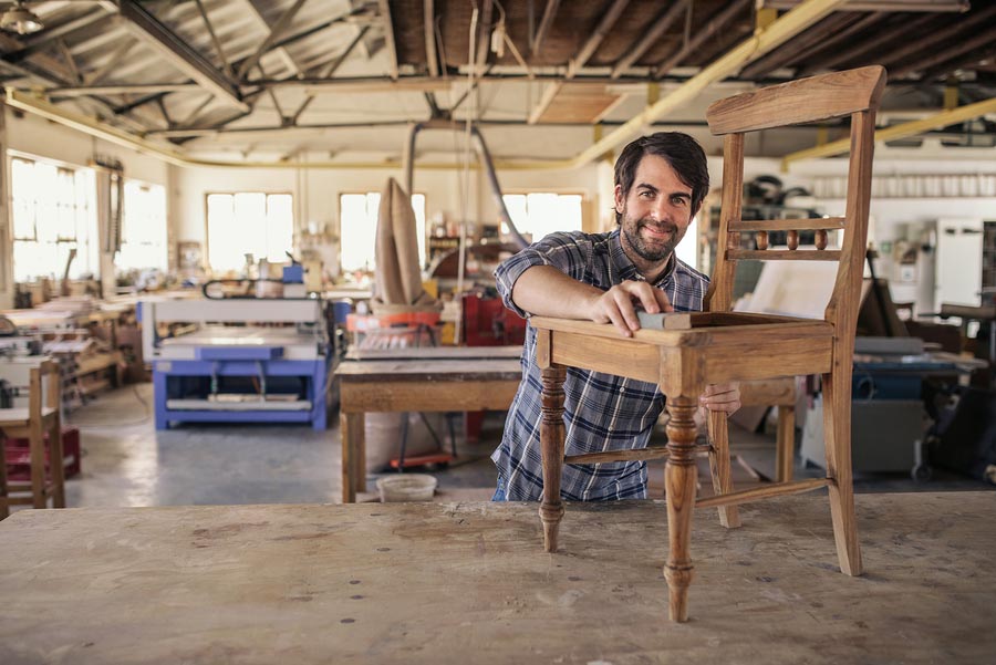 Smiling Man making a specific piece of furniture